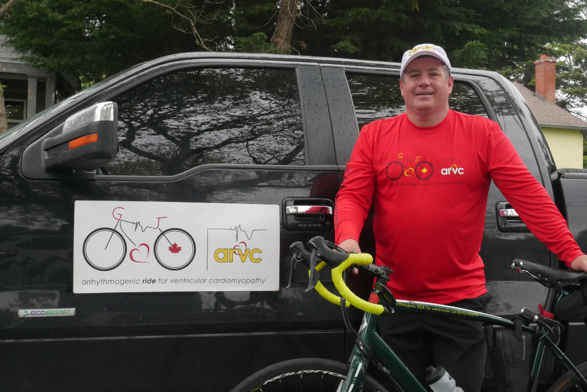Adam Hoerdt stands with his bicycle by his truck and initiative logo Thursday in Fairfield, prior to leaving Sunday on the second leg of his cross-Canada cycling fundraiser for ARVC. The heart condition killed Hoerdt’s wife and affects seven other family members, including his two sons. (Evert Lindquist/News Staff)