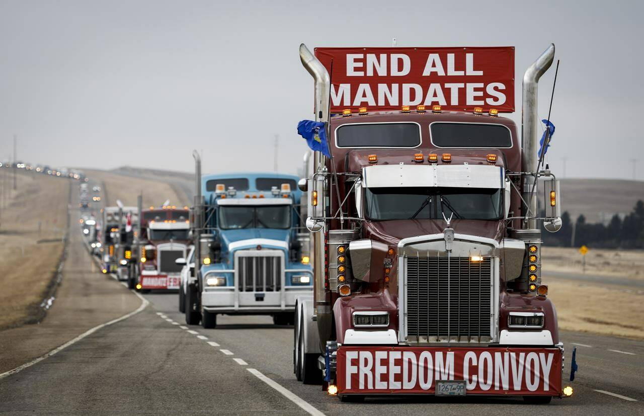 Demonstrators against COVID-19 vaccine mandates and other pandemic restrictions leave in a truck convoy after blocking the highway at the busy border crossing near Coutts, Alta., on Tuesday, Feb. 15, 2022. A Lethbridge man who was charged with conspiracy to commit murder at the border blockade has been denied bail. THE CANADIAN PRESS/Jeff McIntosh