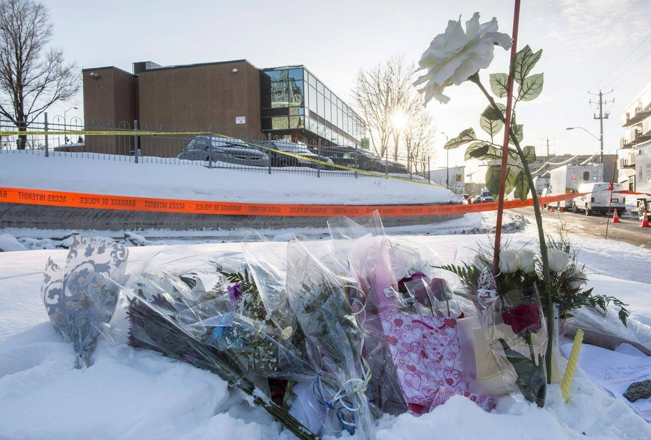 Flowers are seen near a mosque where a shooting left six people dead and eight others injured on Jan. 30, 2017 in Quebec City. The Supreme Court of Canada struck down a Criminal Code provision Friday that meant multiple murderers might have to wait 50 years or more to apply for parole. The unanimous high court decision came Friday in the case of Alexandre Bissonnette, allowing him to seek parole after serving 25 years behind bars for fatally shooting six people at the Quebec City mosque in 2017. THE CANADIAN PRESS/Paul Chiasson