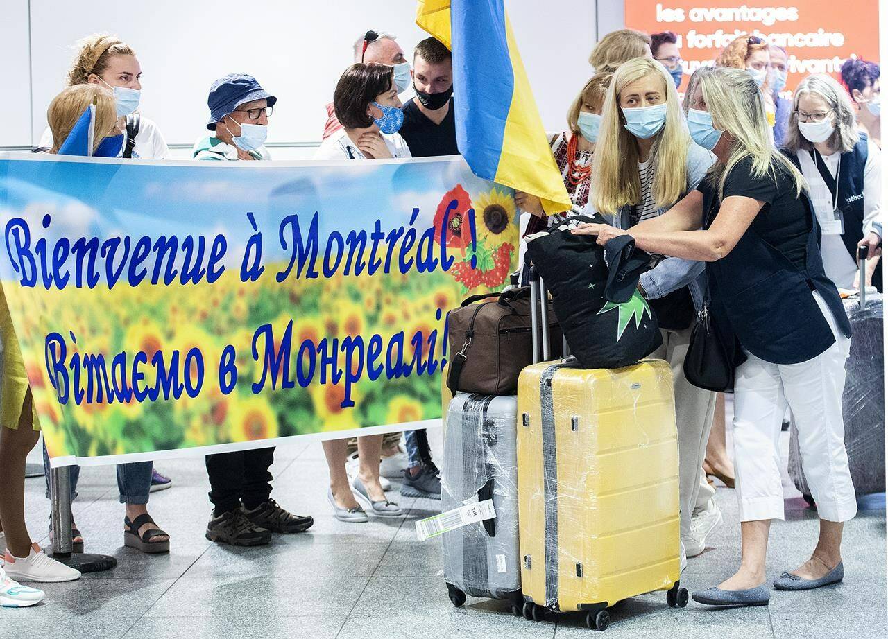 Ukrainian nationals fleeing the ongoing war in Ukraine arrive at Trudeau Airport in Montreal, Sunday, May 29, 2022. THE CANADIAN PRESS/Graham Hughes