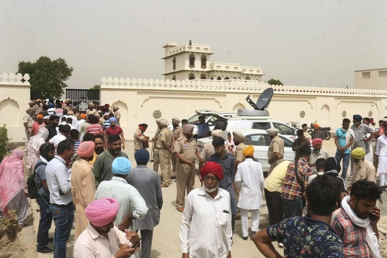 Villagers gather outside the residence of Shubhdeep Singh Sidhu, also known around the world by his stage name Sidhu Moose Wala, in Musa village, near in Mansa, Punjab state, India, Monday, May 30, 2022. Indian police are investigating the killing of the popular Punjabi rapper, who blended hip-hop, rap and folk music, a day after he was fatally shot. (AP Photo)