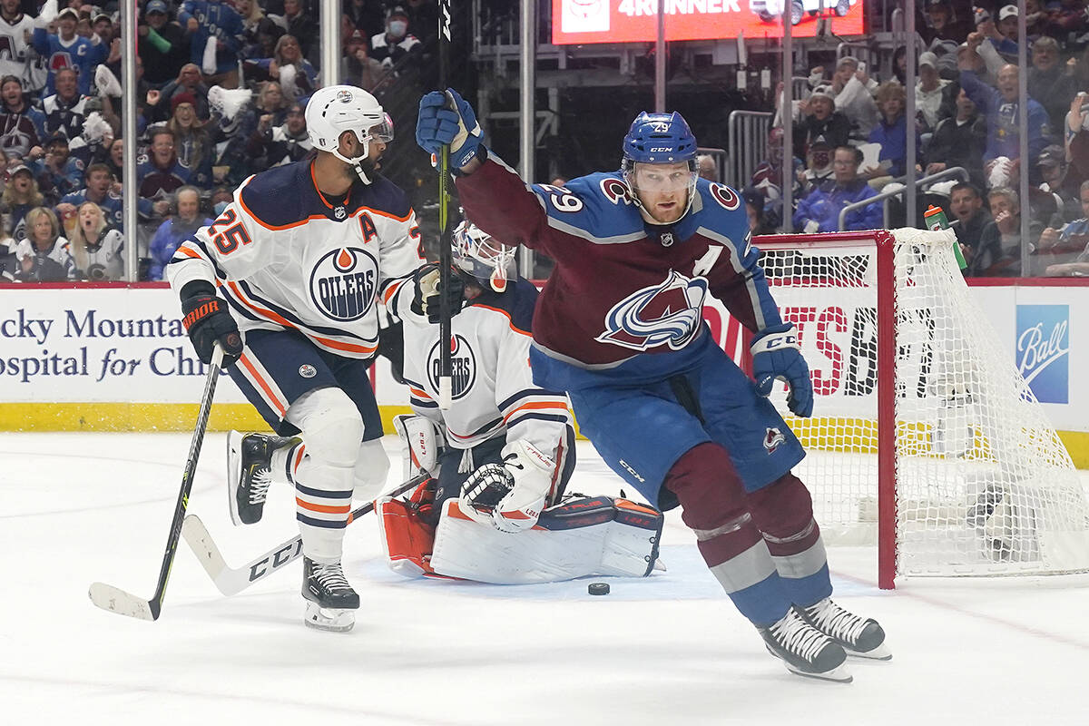 Colorado Avalanche centre Nathan MacKinnon (29) celebrates a goal against Edmonton Oilers goaltender Mike Smith, rear, during the first period in Game 1 of the NHL hockey Stanley Cup playoffs Western Conference finals Tuesday, May, 31, 2022, in Denver. (AP Photo/Jack Dempsey)