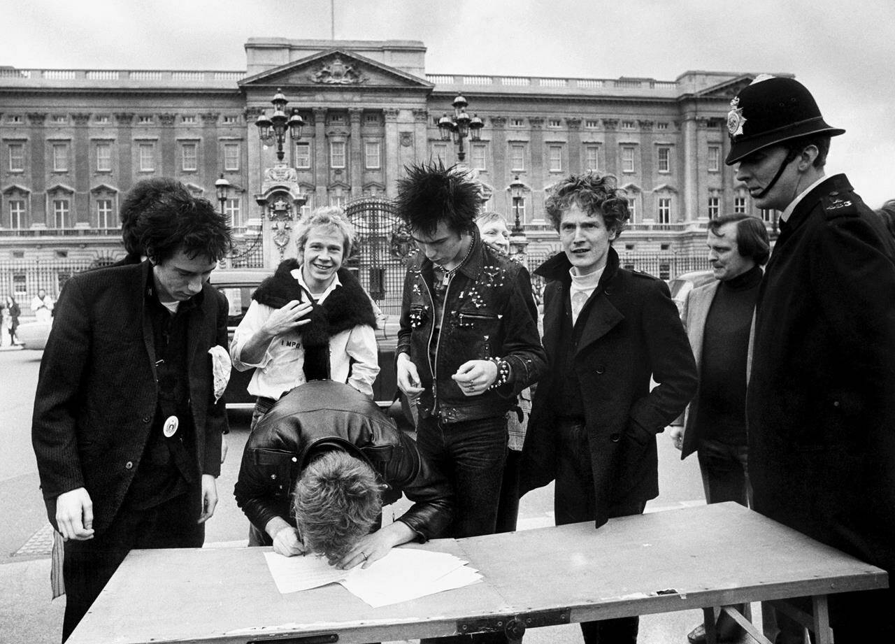 British group, the Sex Pistols, sign a new recording contract with A&M Records outside Buckingham Palace in London, 1977. In Britain, there are several traditional elements to a royal anniversary: pageants, street parties, the Sex Pistols. Queen Elizabeth II and the Pistols have been linked since the punk pioneers released the song “God Save the Queen” in 1977 during the monarch’s Silver Jubilee. The anti-authoritarian anthem has been re-released to mark the queen’s Platinum Jubilee, 70 years on the throne. (PA via AP, File)