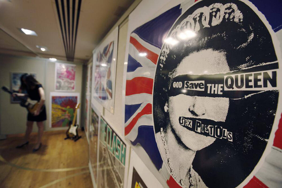 A promotional poster for the 1977 single God Save The Queen by the Sex Pistols on display, during a photo-op ahead of a rock and pop memorabilia auction, in central London, Thursday June 25, 2009. In Britain, there are several traditional elements to a royal anniversary: pageants, street parties, the Sex Pistols. Queen Elizabeth II and the Pistols have been linked since the punk pioneers released the song “God Save the Queen” in 1977 during the monarch’s Silver Jubilee. (AP Photo/Lefteris Pitarakis, File)