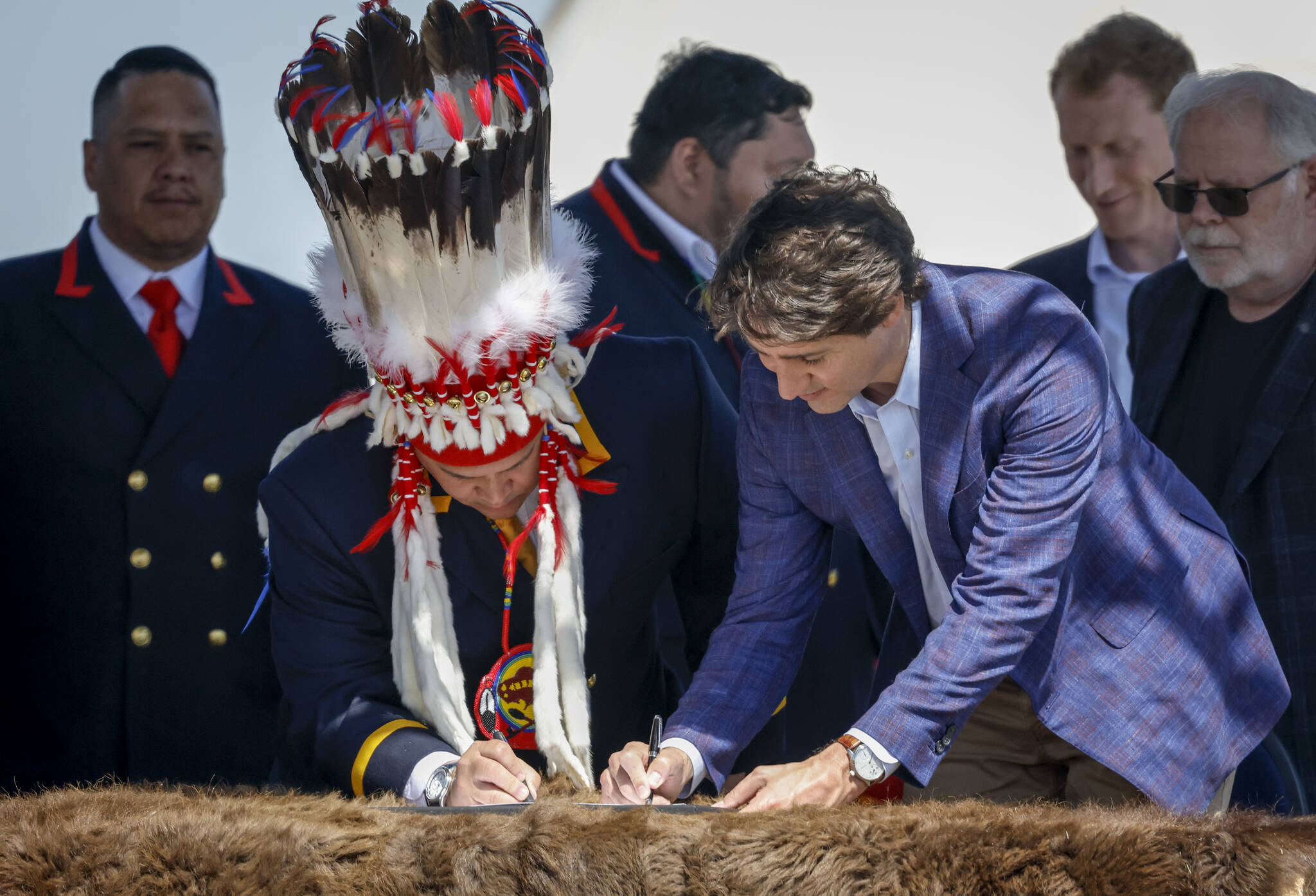 Prime Minister Justin Trudeau, right, and Siksika Nation Chief Ouray Crowfoot participate in a signing ceremony on the Siksika Nation in Siksika Nation, Alta., Thursday, June 2, 2022.THE CANADIAN PRESS/Jeff McIntosh
