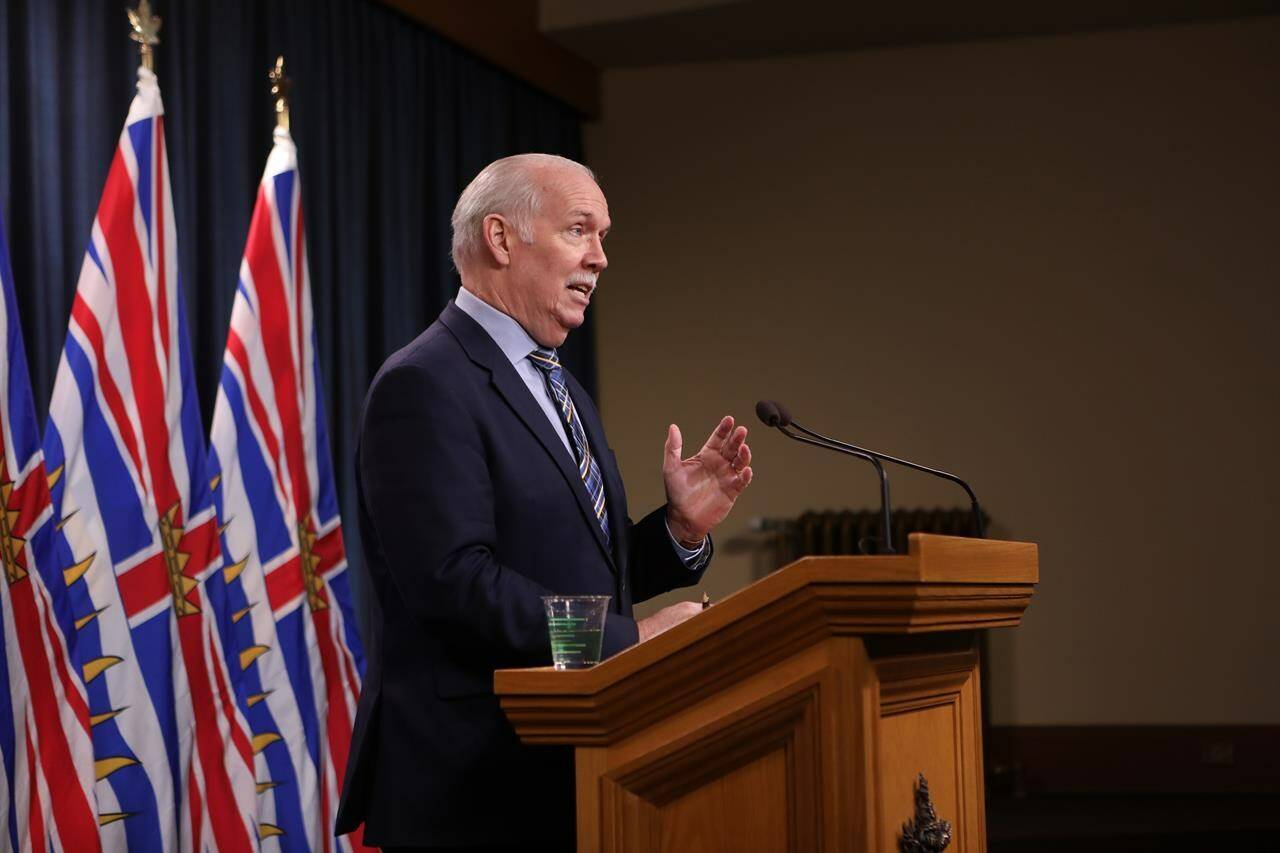 Premier John Horgan answers questions during a news conference in the press theatre at the legislature in Victoria, Friday, March 11, 2022. THE CANADIAN PRESS/Chad Hipolito