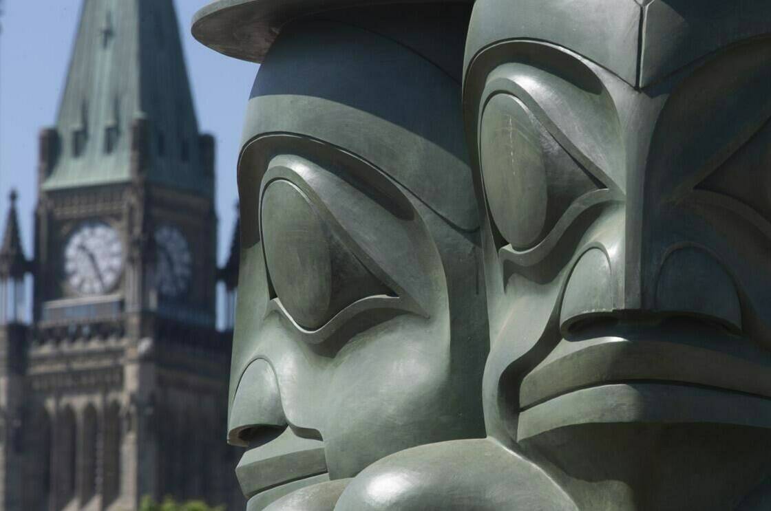 The Three Watchmen statue, created by hereditary chief of the Staast’as Eagle Clan James Hart, is seen near Parliament Hill on Wednesday June 2, 2021. Advocacy groups are to weigh in on any progress made in the year since the federal government released a plan to end violence against Indigenous women, girls and gender diverse people. THE CANADIAN PRESS/Adrian Wyld