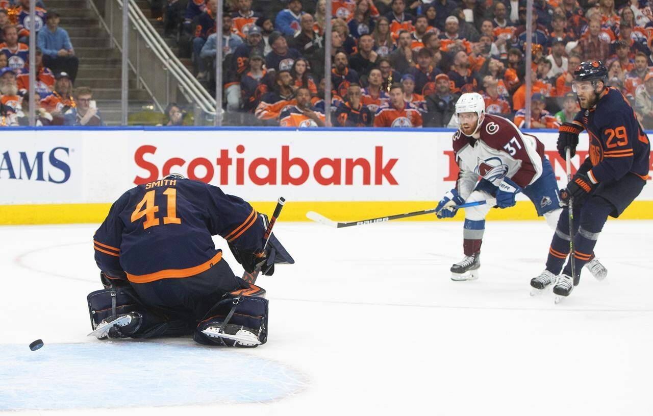 Colorado Avalanche left wing J.T. Compher (37) scores on Edmonton Oilers goalie Mike Smith (41) as Leon Draisaitl (29) defends during third period NHL conference finals action in Edmonton on Saturday, June 4, 2022.THE CANADIAN PRESS/Jason Franson