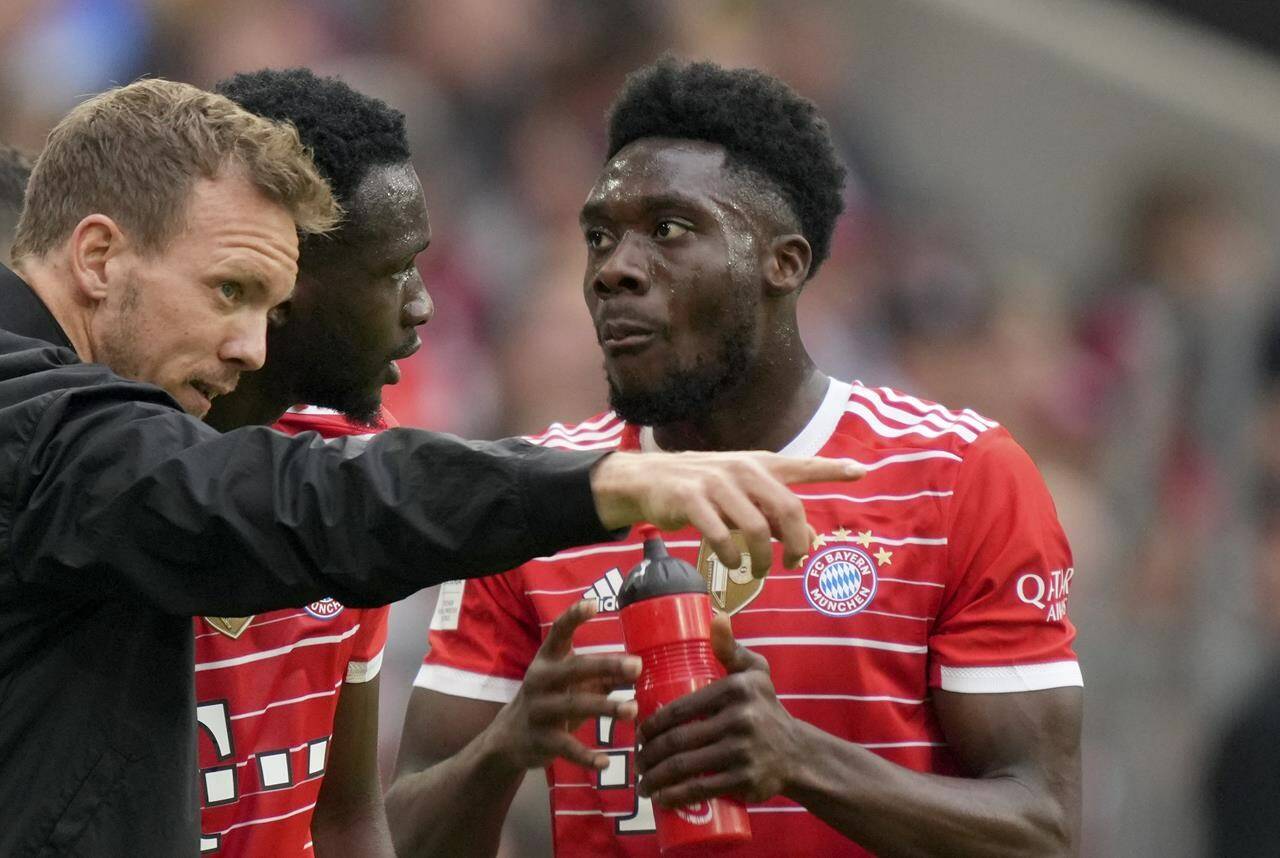 Bayern’s head coach Julian Nagelsmann, left, gives instructions to Tanguy Nianzou, center, and Alphonso Davies during the German Bundesliga soccer match between Bayern Munich and Stuttgart, at the Allianz Arena, in Munich, Germany, Sunday, May 8, 2022. (AP Photo/Michael Probst )