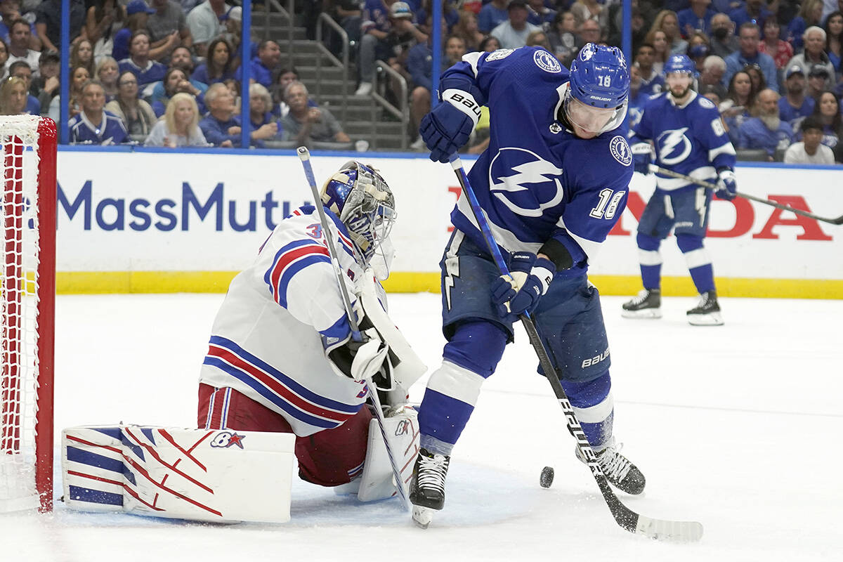 New York Rangers goaltender Igor Shesterkin (31) makes a wave on a deflection by Tampa Bay Lightning left wing Ondrej Palat (18) during the second period in Game 3 of the NHL hockey Stanley Cup playoffs Eastern Conference finals Sunday, June 5, 2022, in Tampa, Fla. (AP Photo/Chris O’Meara)