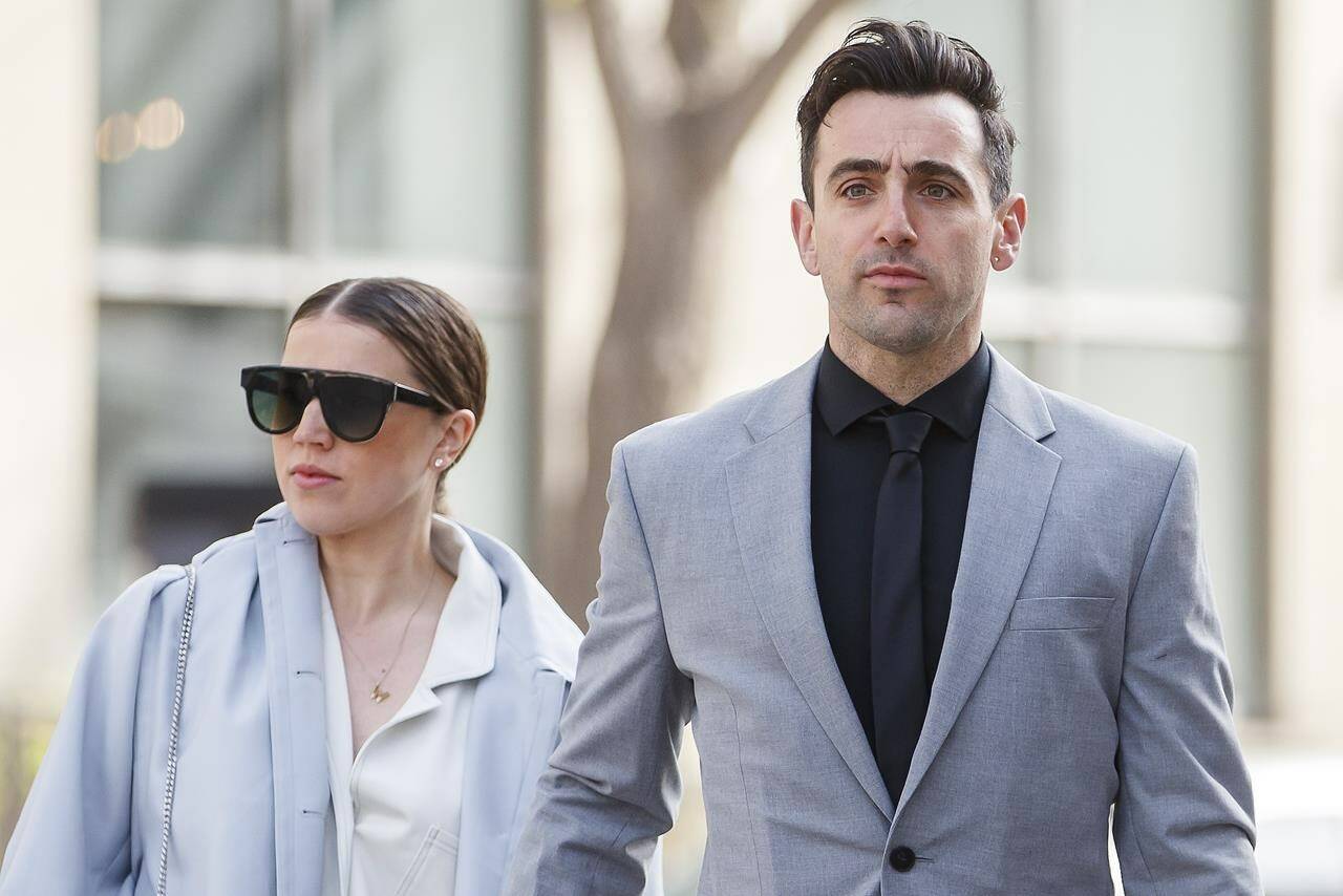 Canadian musician Jacob Hoggard arrives alongside his wife Rebekah Asselstine, for his sex assault trial at the Toronto courthouse, in Toronto, Tuesday, May 10, 2022. THE CANADIAN PRESS/Cole Burston