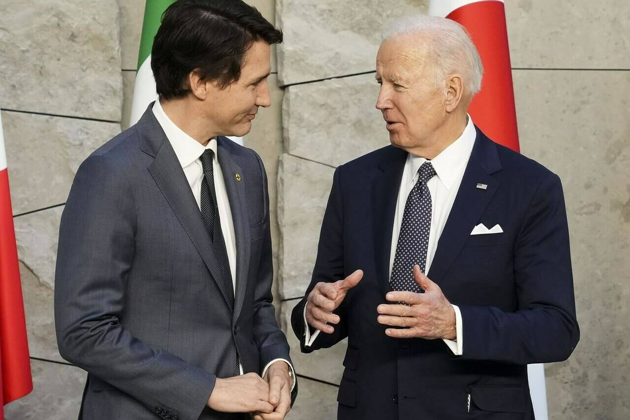 Prime Minister Justin Trudeau and U.S. President Joe Biden talk as they take part in a G7 family photo at NATO headquarters in Brussels, Belgium on Thursday, March 24, 2022. THE CANADIAN PRESS/Sean Kilpatrick