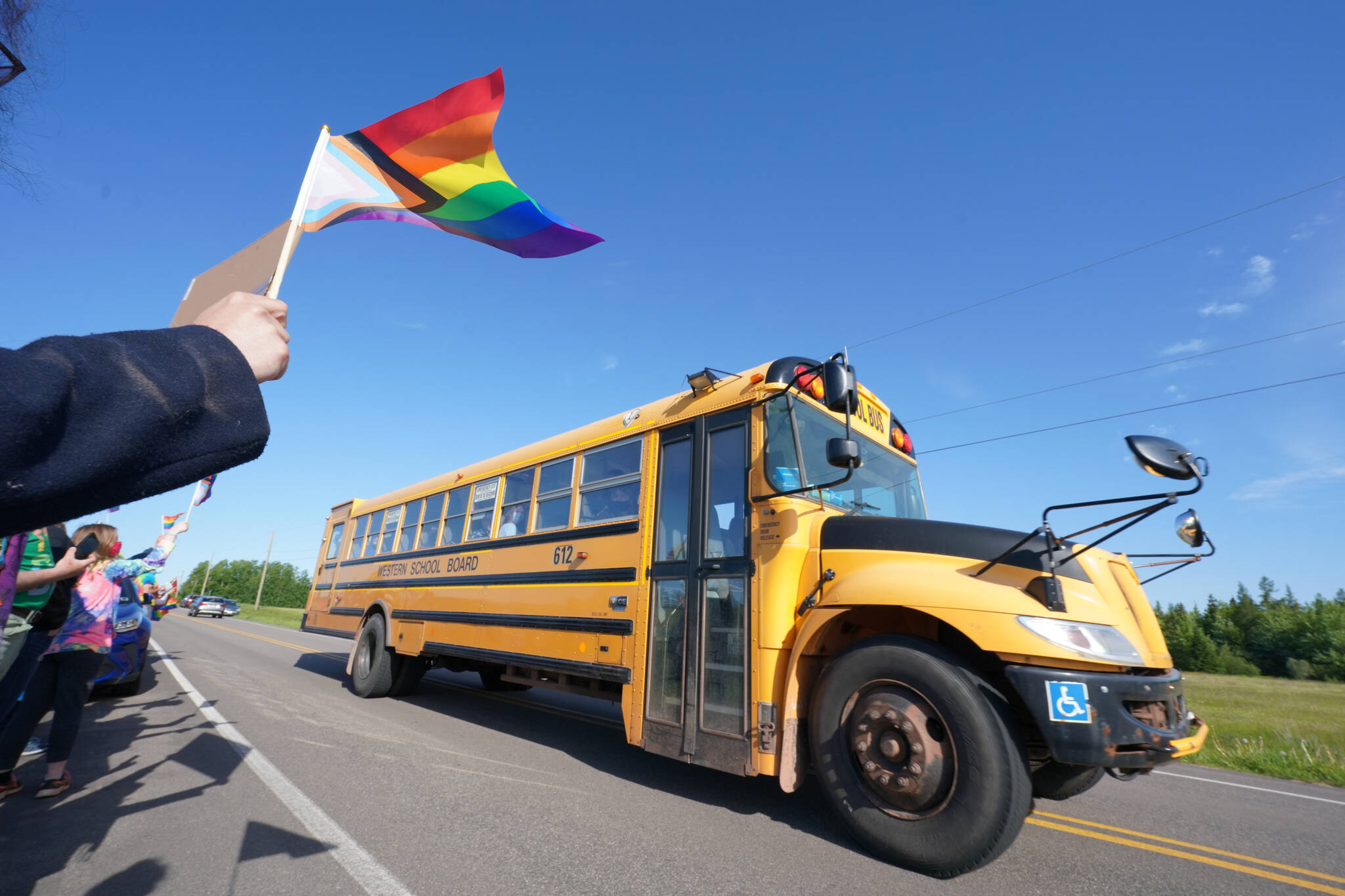 LGBTQ supporters wave their flags to show support for students going to school at East Wiltshire School in Cornwall, Prince Edward Island on Monday June 14, 2021. THE CANADIAN PRESS/John Morris