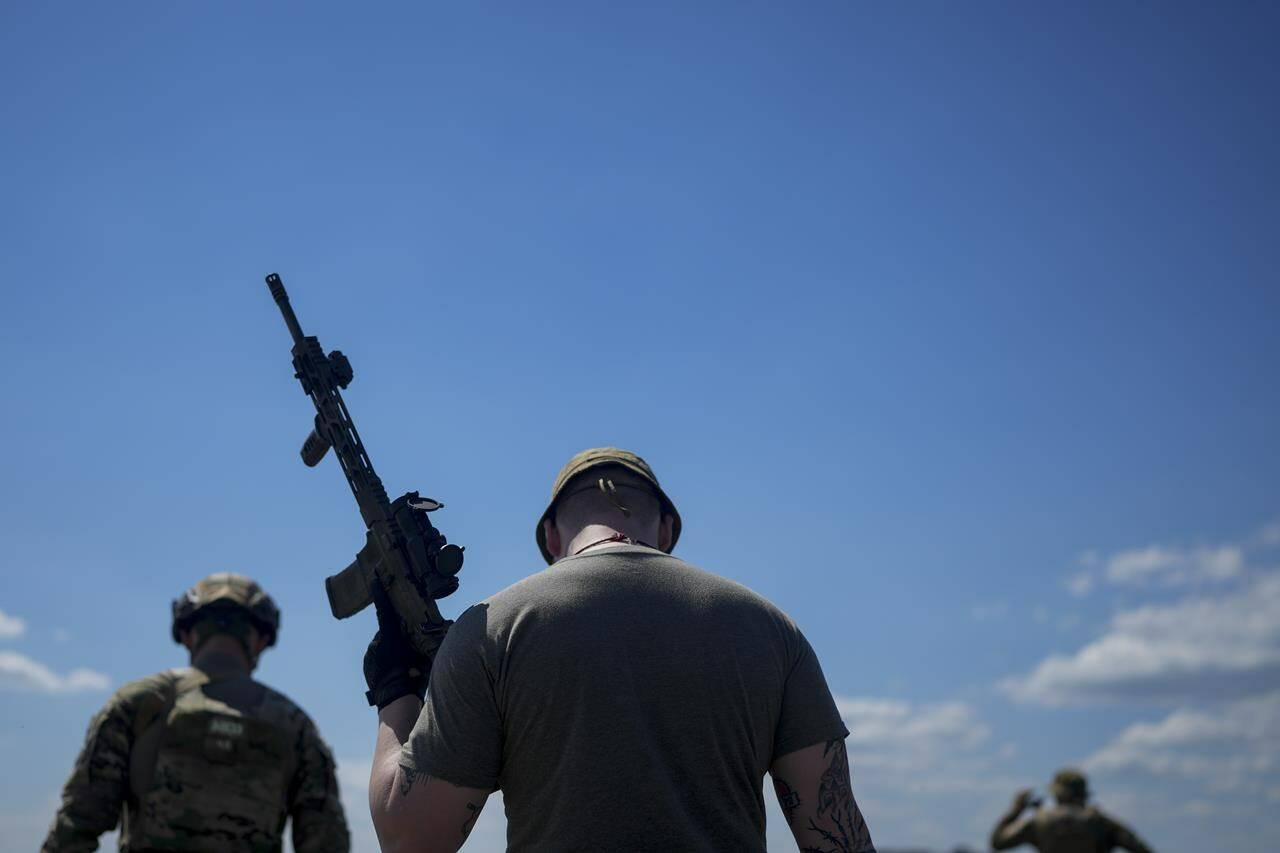 A civilian militia man holds a rifle during training at a shooting range in outskirts Kyiv, Ukraine, Tuesday, June 7, 2022. A University of Calgary analysis of over 6 million tweets and retweets - and where they originate from - has found that Canada is being targeted by foreign powers trying to influence public opinion here. THE CANADIAN PRESS/AP Photo/Natacha Pisarenko