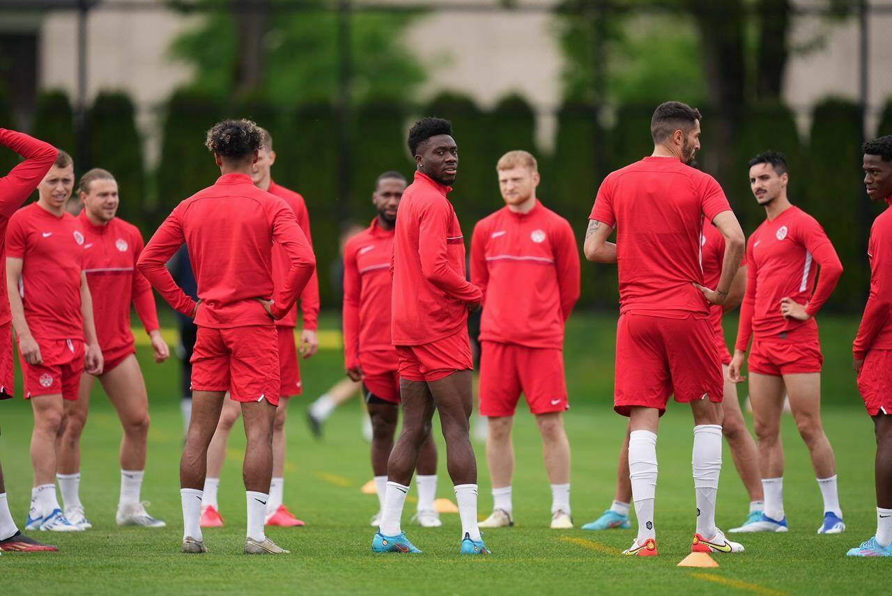 Canadian national men’s soccer team forward Alphonso Davies, centre, stands with his teammates during a training session for a CONCACAF Nations League match against Curacao in Vancouver on Tuesday, June 7, 2022. After a drama-filled week away from the field, Canada’s men’s soccer team will finally take the field in front of hometown fans again tonight. THE CANADIAN PRESS/Darryl Dyck