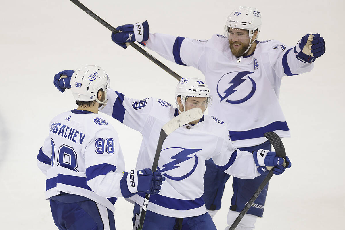 Tampa Bay Lightning centre Ross Colton (79) and defenceman Victor Hedman (77) celebrate with defenceman Mikhail Sergachev (98) after Sergachev scored a goal against the New York Rangers during the second period in Game 5 of the NHL Hockey Stanley Cup playoffs Eastern Conference Finals, Thursday, June 9, 2022, in New York (AP Photo/Adam Hunger)