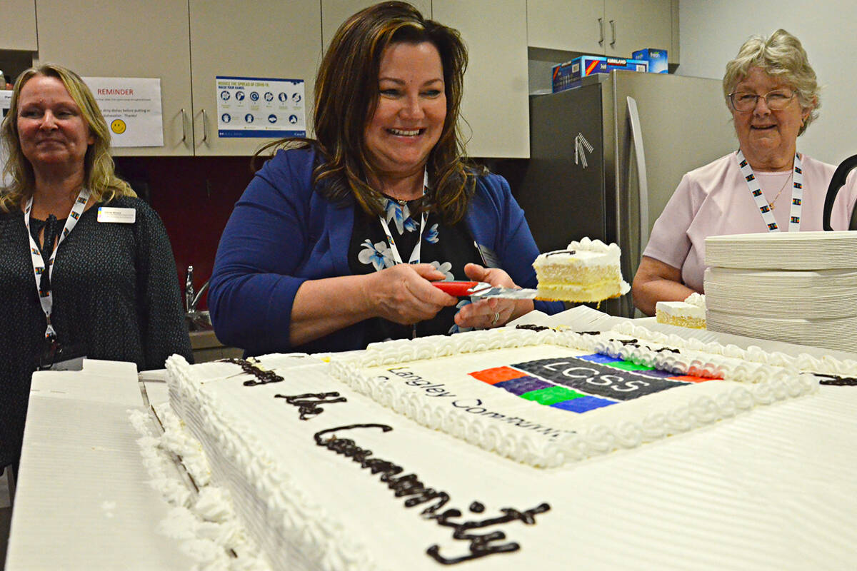 Karen Fraser of Child Care Resource and Referral helped serve up cake at a Monday, June 6 celebration marking the 50th anniversary of the Langley Community Services Society. (Heather Colpitts/Langley Advance Times)