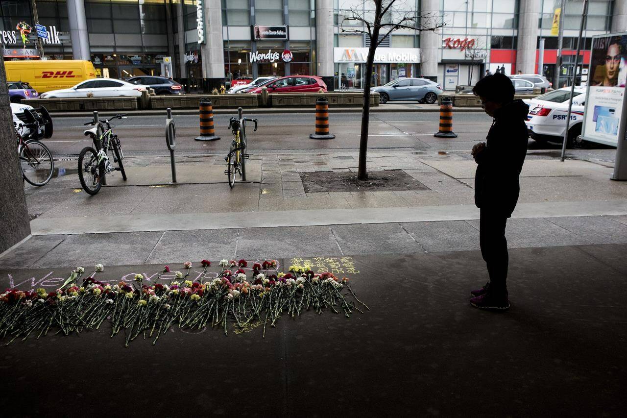 A woman stops to pay her respect at a makeshift memorial to one of the victims being remembered on Tuesday, April 23, 2019. Victims and families of Toronto’s deadly van attack are set to give statements in court today.THE CANADIAN PRESS/Chris Young
