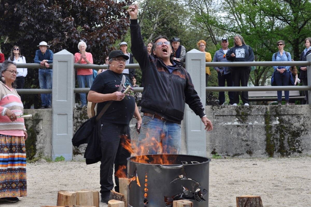 Gary Carden, a Sinixt man, yells Friday in Nelson as he burns a copy of Canada’s 1956 declaration that his people were extinct. Photo: Tyler Harper
