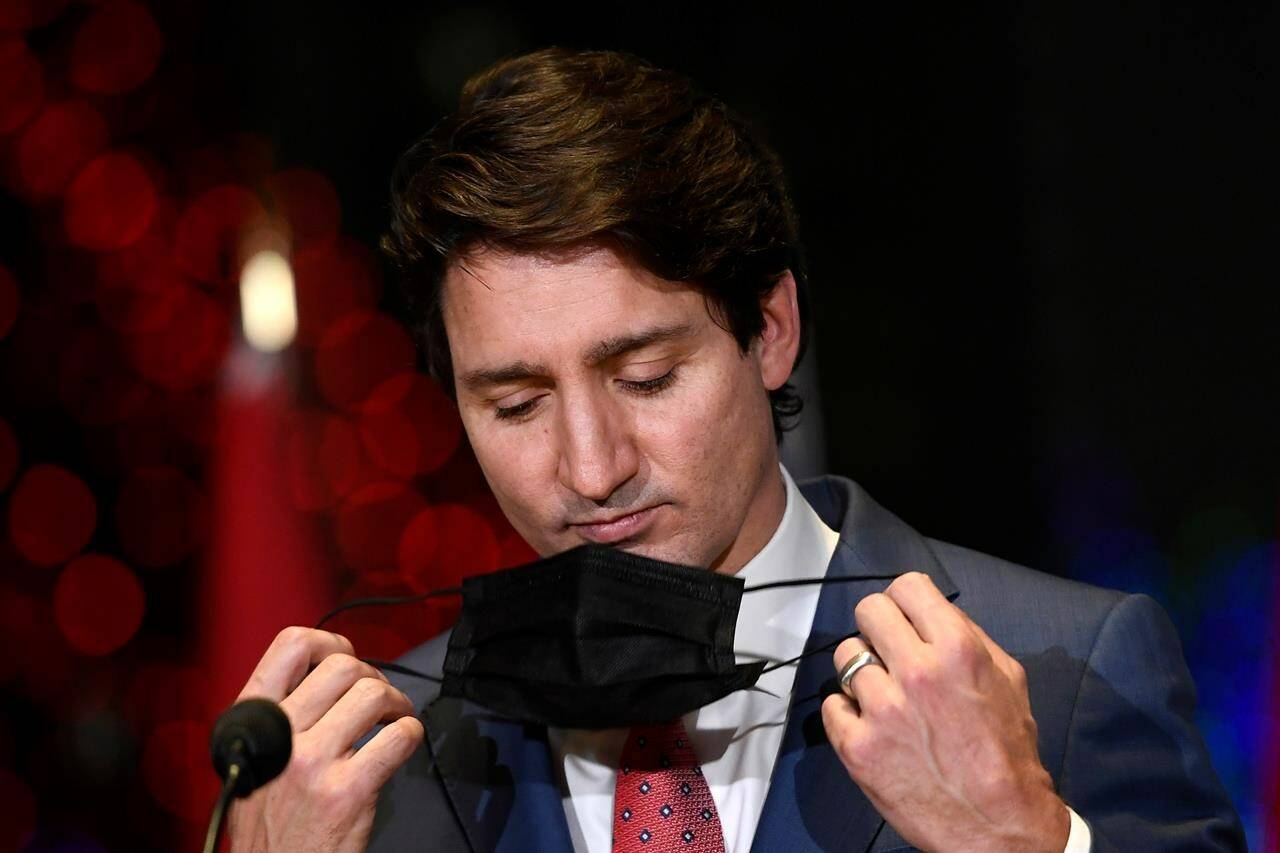 Prime Minister Justin Trudeau removes his mask before answering questions at an announcement in Ottawa, on Wednesday, Dec. 15, 2021. THE CANADIAN PRESS/Justin Tang