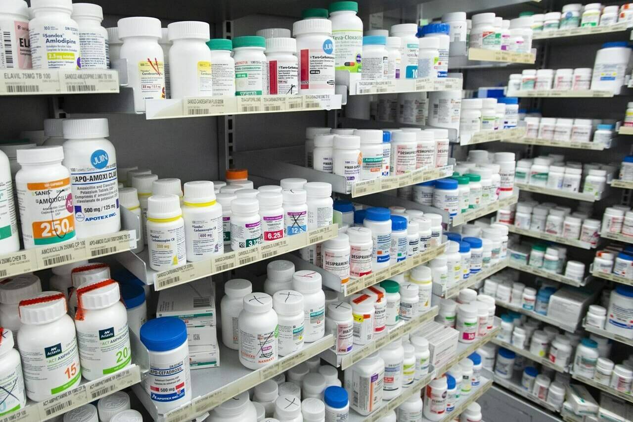 Prescription drugs are seen on shelves at a pharmacy in Montreal, Thursday, March 11, 2021. The Parliamentary Budget Officer says changes to the way Canada sets drug prices will lower drug spending by about seven per cent  over the long term. THE CANADIAN PRESS/Ryan Remiorz