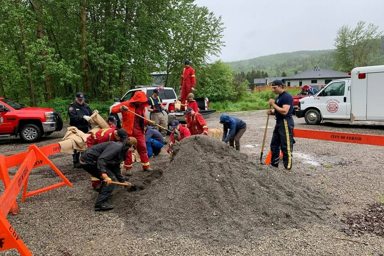 Residents and workers for the City of Fernie, B.C., fill sandbags in preparation for flooding along the Elk River, where heavy rain and spring snow melt threaten to push the river over its banks. THE CANADIAN PRESS/HO-City of Fernie