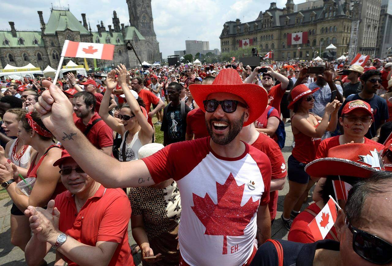 People cheer during Canada Day celebrations on Parliament Hill in Ottawa on Sunday, July 1, 2018. This year will see an “unprecedented and unique Canada Day” with a never-before-seen security posture in the city, says an Ottawa police officer on condition of anonymity at a technical briefing for media on Friday. THE CANADIAN PRESS/Justin Tang