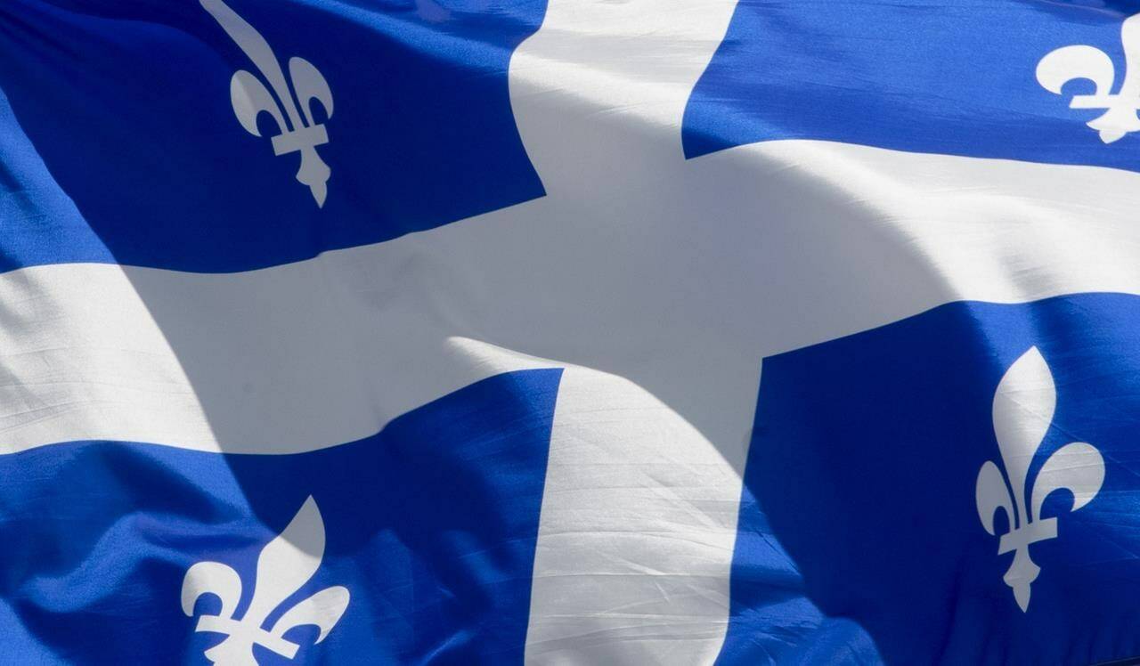 Quebec’s provincial flag flies in Ottawa on June 30, 2020. More people have been asked to evacuate their homes due to the risk of a landslide in one of Saguenay’s neighbourhoods, north of Quebec City, on Saturday night. THE CANADIAN PRESS/Adrian Wyld
