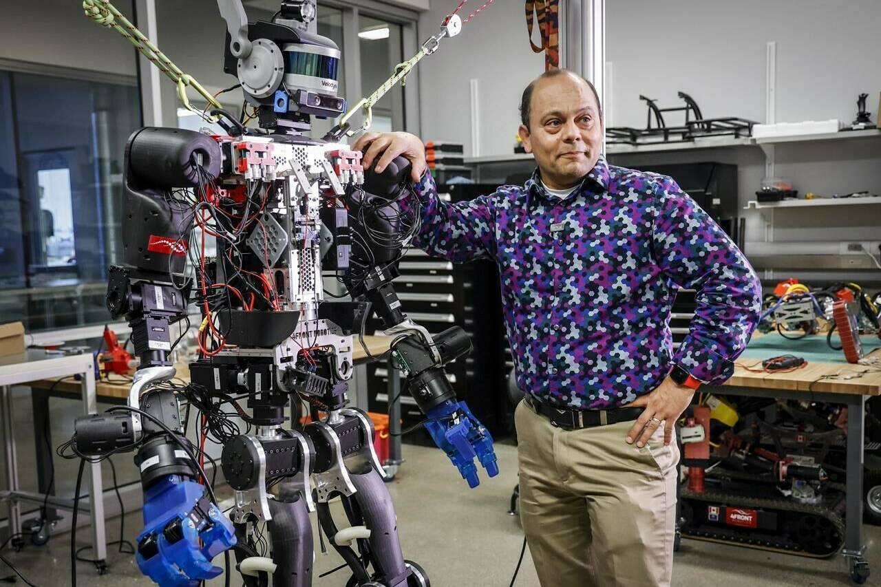 Schulich School of Engineering Prof. Alejandro Ramirez-Serrano leans on one of his robots at the University of Calgary’s unmanned vehicles robotarium lab in Calgary on Tuesday, June 14, 2022. THE CANADIAN PRESS/Jeff McIntosh