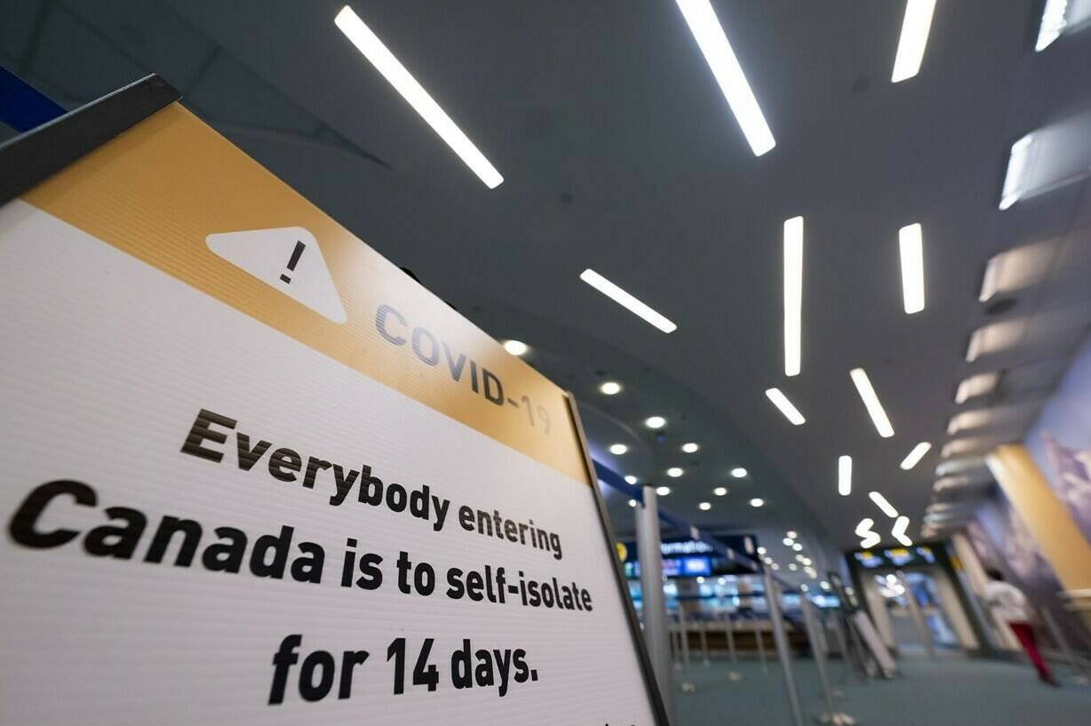 Signage for a COVID-19 screening centre is pictured at Vancouver International Airport in Richmond, B.C. Friday, February 19, 2021. THE CANADIAN PRESS/Jonathan Hayward