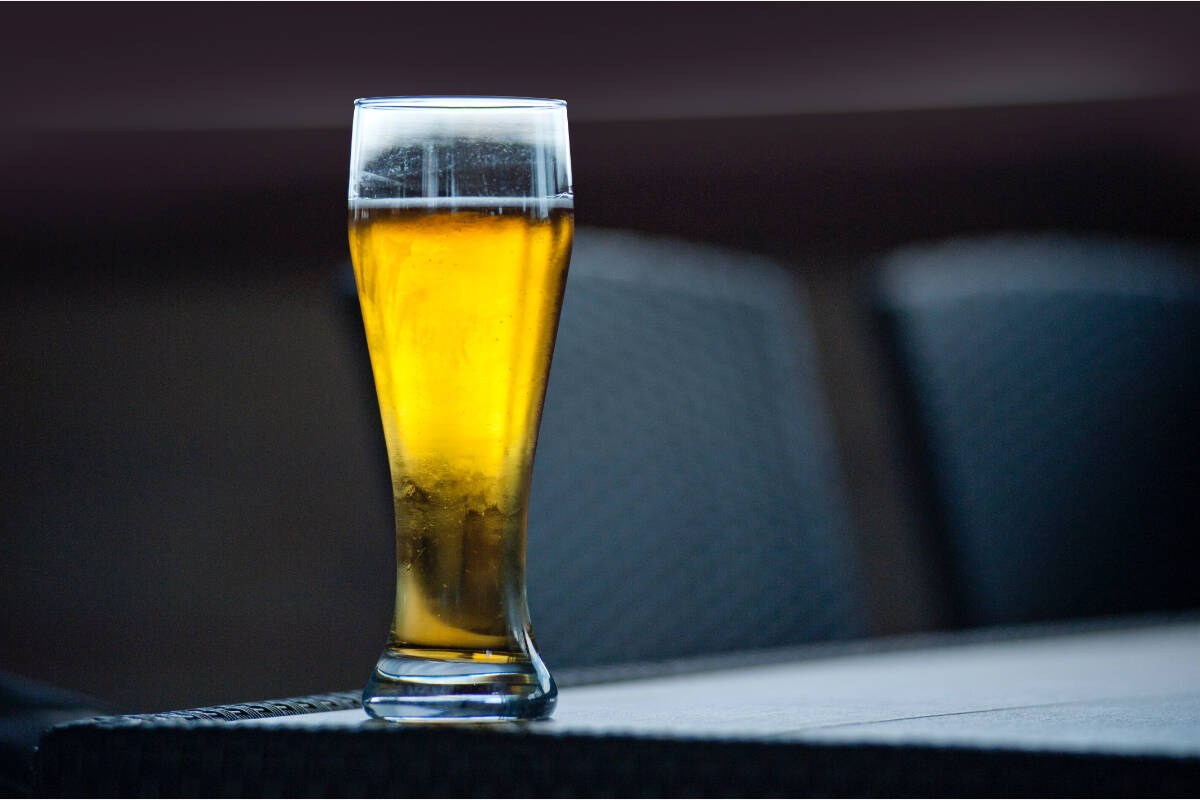 A glass of beer sits on a table. (Pexels photo)