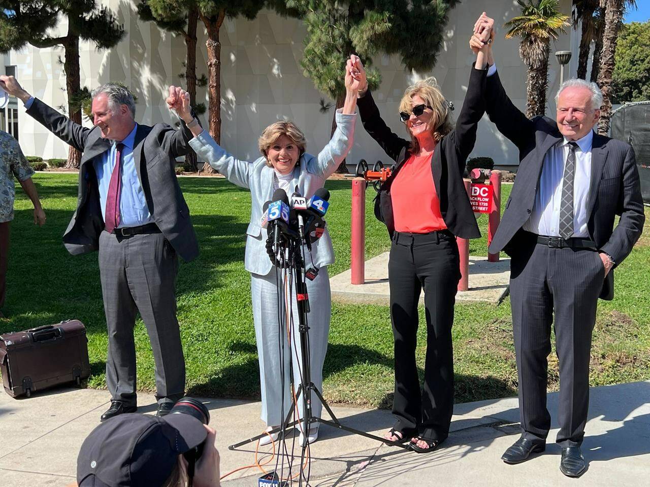 Attorneys John West, from left, Gloria Allred, plaintiff Judy Huth and attorney Nathan Goldberg join arms following a verdict in Huth’s favour in a civil trial involving actor Bill Cosby outside the Santa Monica Courthouse on Tuesday, March 21, 2022. Jurors found that Cosby sexually abused then 16-year-old Huth at the Playboy Mansion in 1975. (AP Photo/Richard Taber)