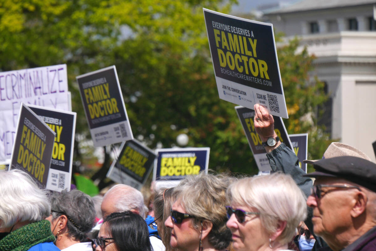 Dozens hold signs and show support at the BC Health Care Matters rally on May 19, 2022, at the legislature for World Family Doctor Day. (Evert Lindquist/News Staff)