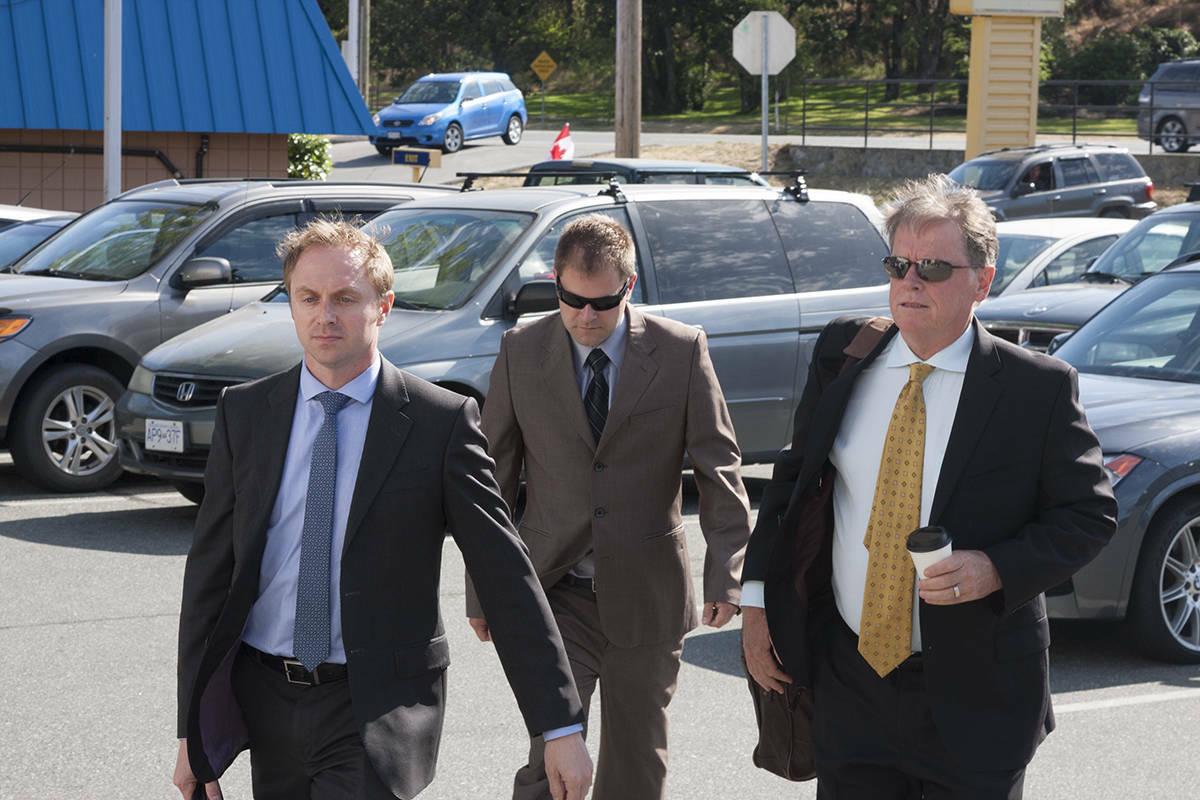 Kenneth Jacob Fenton, flanked by his lawyers Chris Masey and Dale Marshall, heads into the second day of sentencing in 2017 for charges that stemmed from the crash that led to the 2016 death of West Shore RCMP officer Const. Sarah Beckett. (Black Press Media file photo)