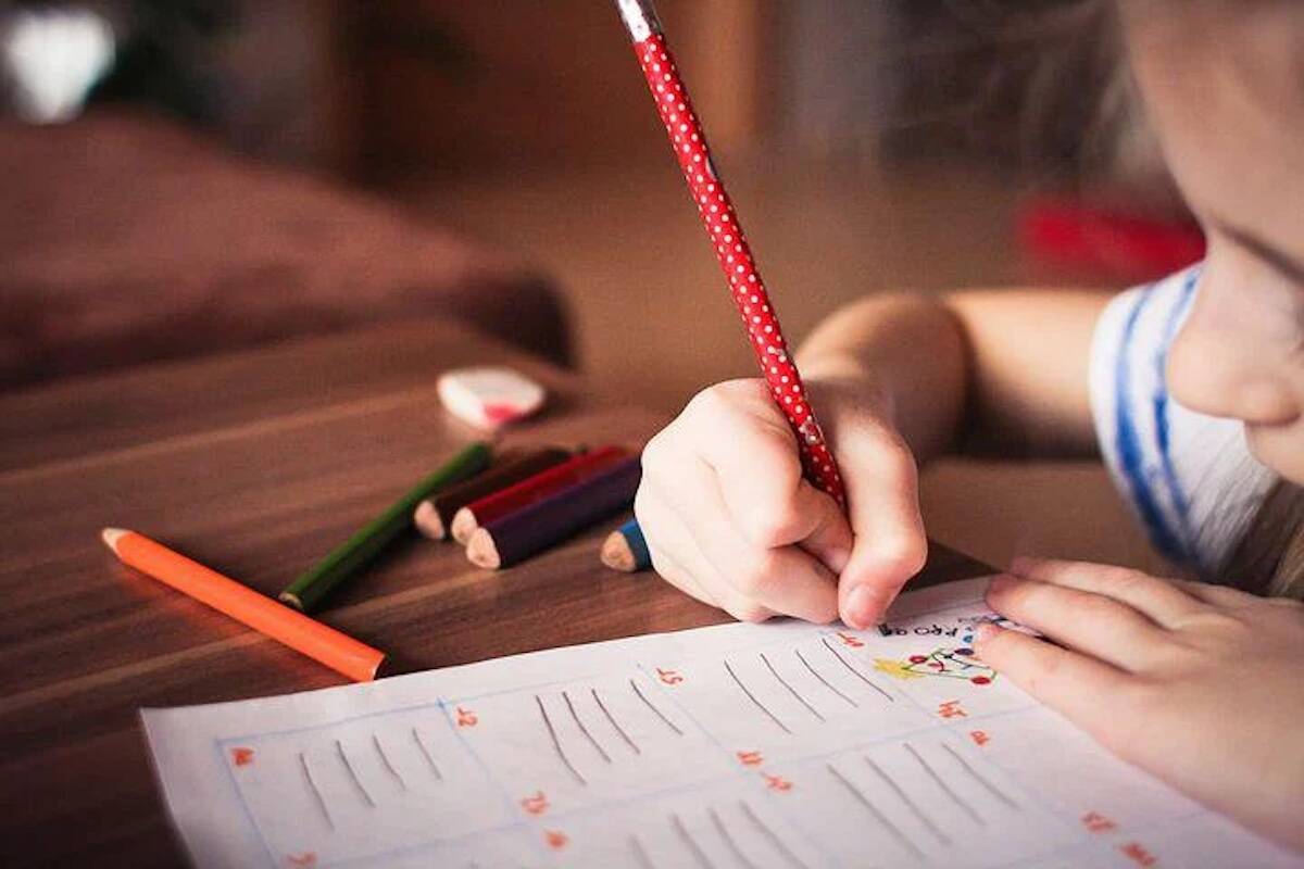 Photo of child working on a worksheet (Pixabay image).