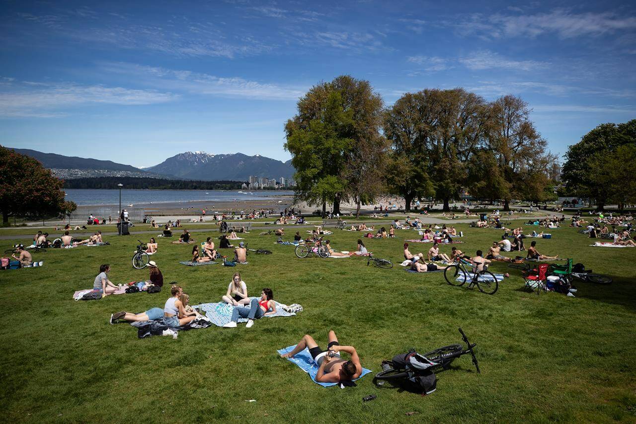 People sit and lie in the sun at Kitsilano Beach Park as temperatures reached highs into 20s in Vancouver on Saturday, May 9, 2020,. (Photo: THE CANADIAN PRESS/Darryl Dyck).
