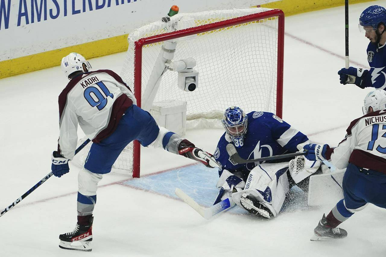 Colorado Avalanche centre Nazem Kadri shoots the puck into the top of the goal past Tampa Bay Lightning goaltender Andrei Vasilevskiy (88) for a goal during overtime of Game 4 of the NHL hockey Stanley Cup Finals on Wednesday, June 22, 2022, in Tampa, Fla. (AP Photo/John Bazemore)