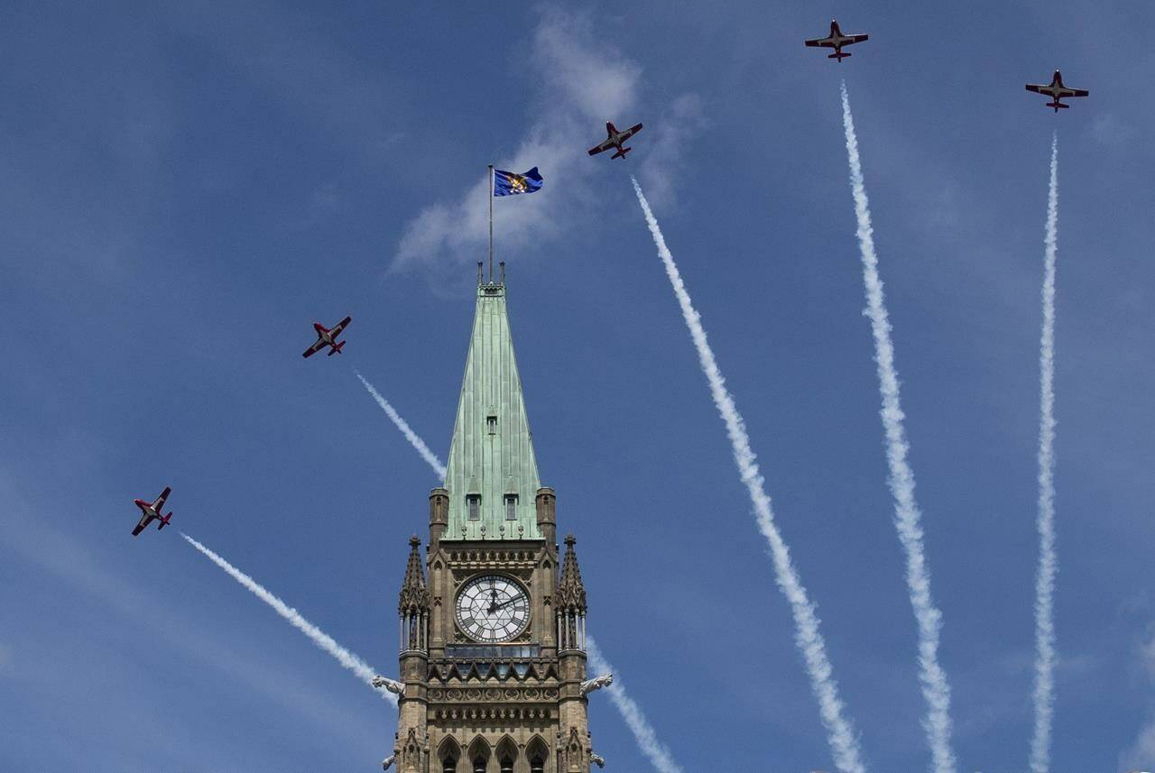 Royal Canadian Air Force Snowbirds fly past the Peace Tower during the Canada Day noon show on Parliament Hill in Ottawa on Monday, July 1, 2019. The Department of National Defence says the Canadian Forces Snowbirds will be unable to fly in planned air shows and fly pasts until a technical issue is resolved. THE CANADIAN PRESS/Justin Tang