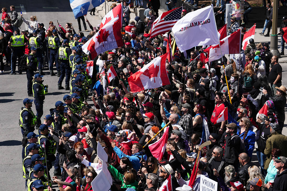 Police hold the line as protesters gather during a demonstration, part of a convoy-style protest participants are calling “Rolling Thunder”, in Ottawa, Saturday, April 30, 2022. THE CANADIAN PRESS/Sean Kilpatrick