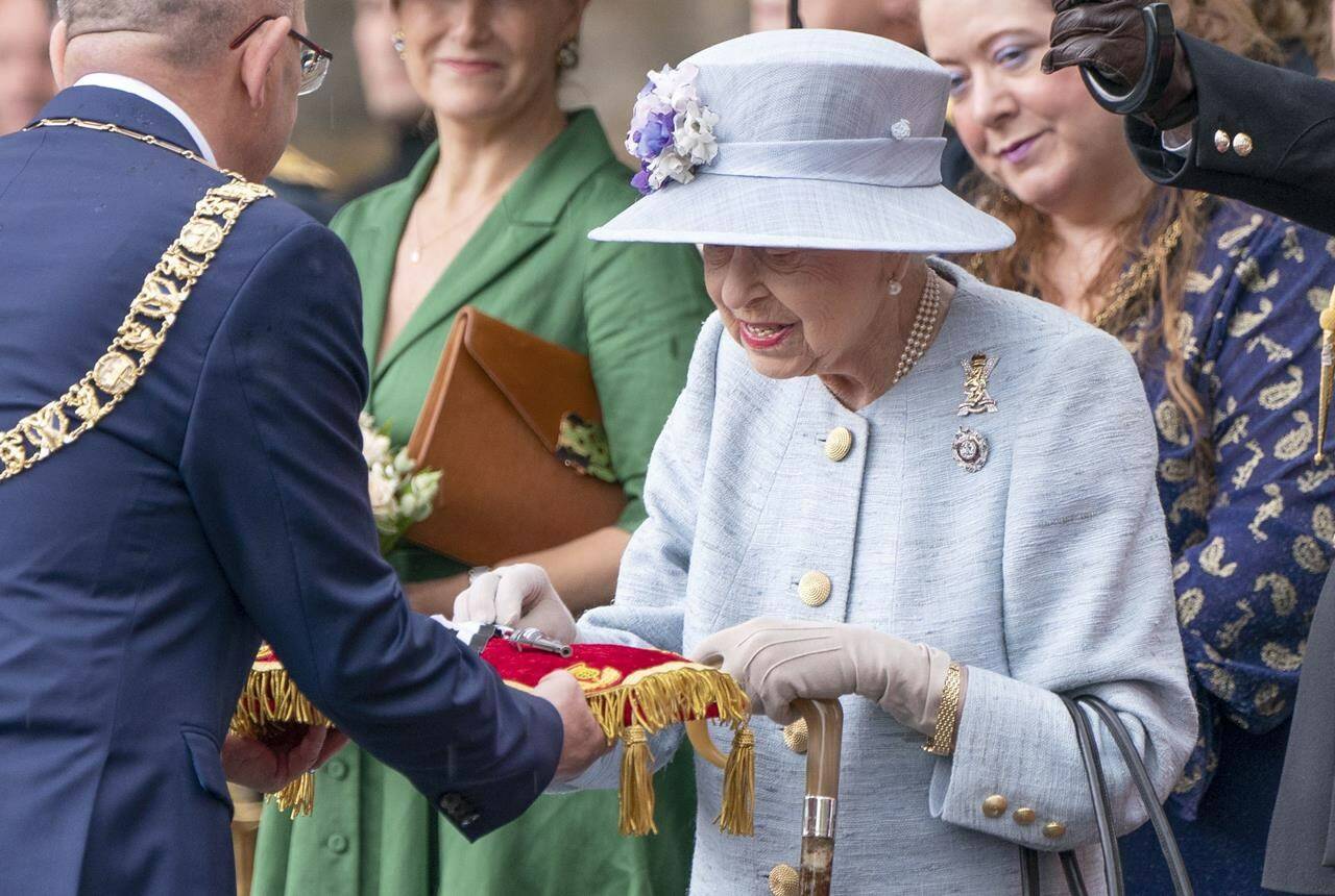 Britain’s Queen Elizabeth II inspects the keys presented by Lord Provost Robert Aldridge, left, during the Ceremony of the Keys on the forecourt of the Palace of Holyroodhouse in Edinburgh during her traditional trip to Scotland for Holyrood Week, Monday, June 27, 2022. Most people in Canada do not think “new Canadians” should have to swear an oath of allegiance to the Queen and her heirs when they take the oath of citizenship, according to a poll ahead of Canada Day. THE CANADIAN PRESS/AP-PA, Jane Barlow