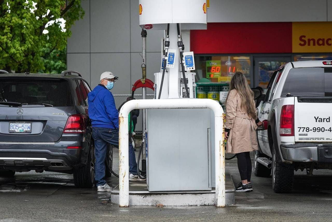 People fuel up vehicles at a Shell gas station after the price of a litre of regular grade gasoline reached a new high of $2.28, in Vancouver, on Saturday, May 14, 2022. Canada’s new emissions standards for gasoline and diesel will allow oil companies that get a federal tax break for installing carbon capture and storage systems to generate credits based on those systems, which they can then sell to refineries and fuel importers. THE CANADIAN PRESS/Darryl Dyck
