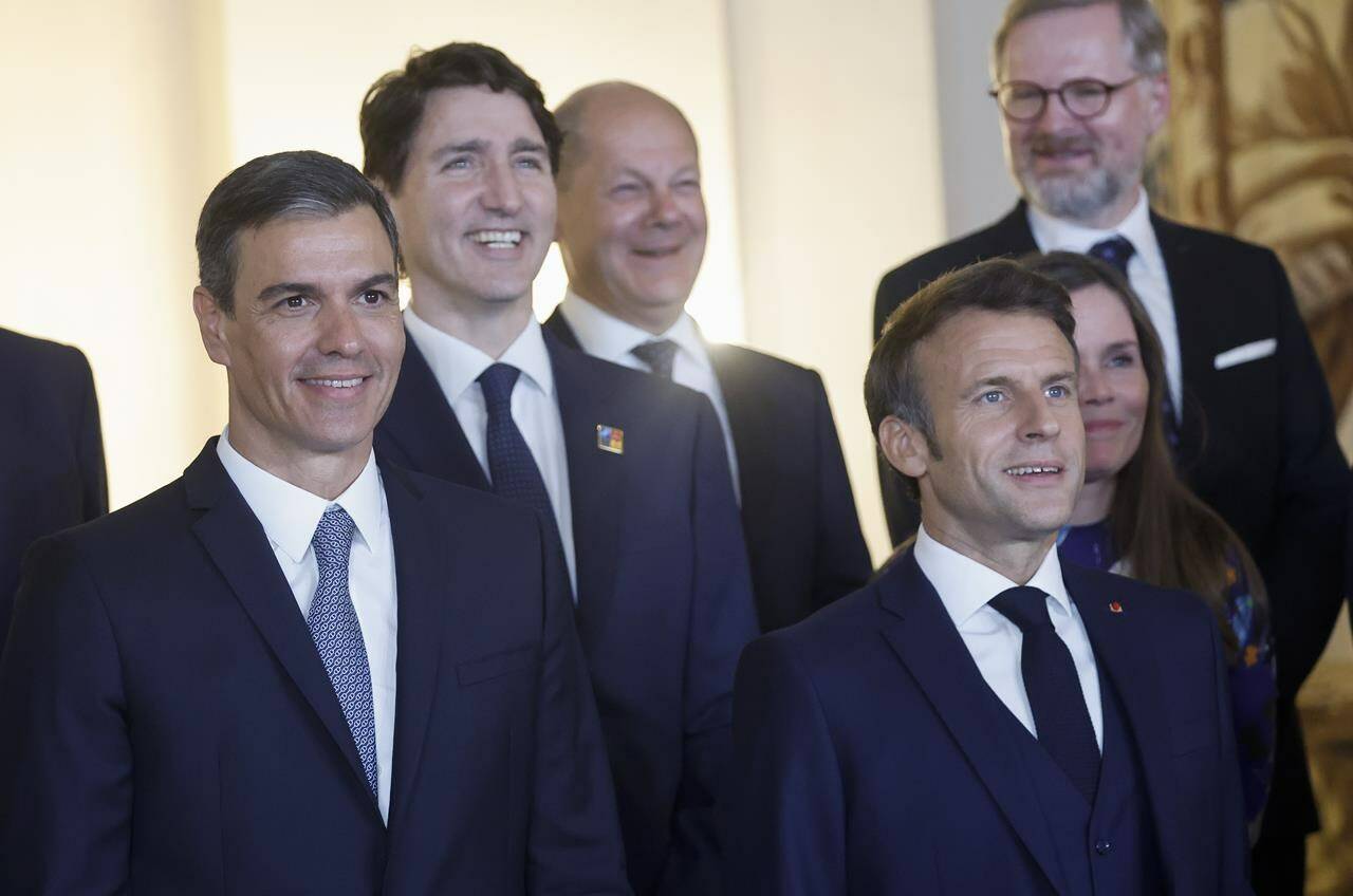 Spain’s Prime Minister Pedro Sanchez, left, France’s President Emmanuel Macron, Canada’s Prime Minister Justin Trudeau, center left, Germany’s Chancellor Olaf Scholz, center, Czech Prime Minister Petr Fiala, and Iceland’s Prime Minister Katrin Jakobsdottir pose for a group photo with Spain’s King Felipe and Queen Letizia and NATO leaders before a gala dinner at the Royal Palace in Madrid, Spain, Tuesday, June 28, 2022. North Atlantic Treaty Organization heads of state will meet for a NATO summit in Madrid from Tuesday through Thursday. THE CANADIAN PRESS/Jonathan Ernst/Pool via AP
