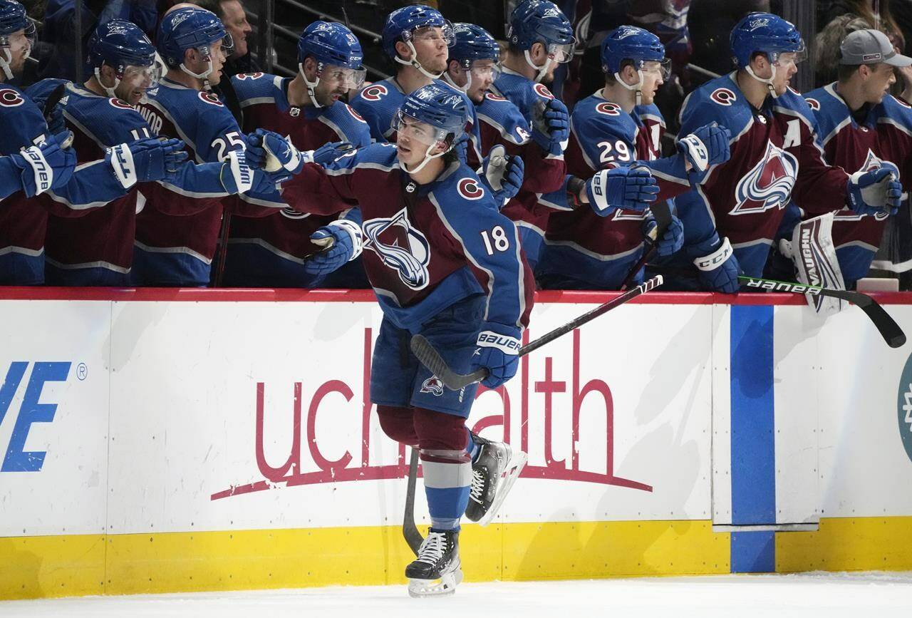 Colorado Avalanche centre Alex Newhook is congratulated by his teammates after scoring a regular-season goal in March. Newhook, a former Victoria Grizzlies star, won a Stanley Cup on Sunday with the Avs following a 2-1 win over two-time defending champion Tampa Bay. (AP Photo/David Zalubowski)