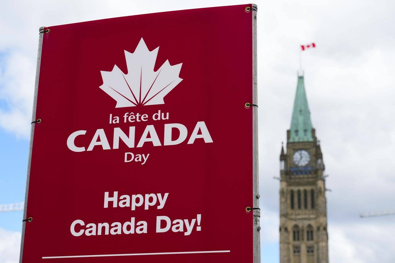 Signs are pictured on Parliament Hill prior to Canada Day, in Ottawa on Monday, June 27, 2022. Many communities are reimagining Canada Day celebrations to recognize Indigenous people as the country continues to reckon with its legacy following the discovery of possible unmarked graves at former residential schools. THE CANADIAN PRESS/Sean Kilpatrick