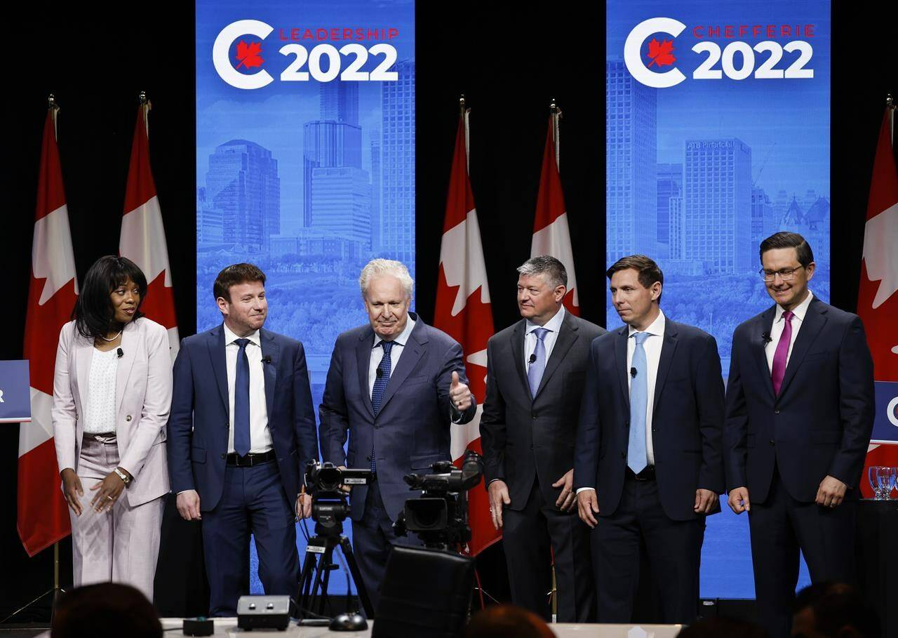 Candidates, left to right, Leslyn Lewis, Roman Baber, Jean Charest, Scott Aitchison, Patrick Brown, and Pierre Poilievre pose on stage following the Conservative Party of Canada English leadership debate in Edmonton, on May 11, 2022. THE CANADIAN PRESS/Jeff McIntosh