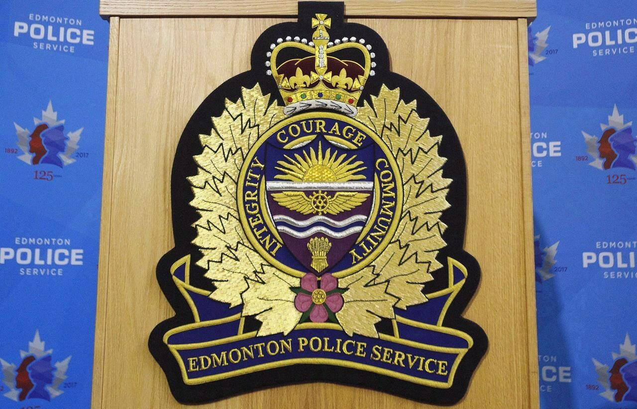 An Edmonton Police Service logo is shown on a lectern at a press conference in Edmonton, Oct. 2, 2017. Police say a missing 13-year-old Edmonton girl has been found alive in the United States. THE CANADIAN PRESS/Jason Franson