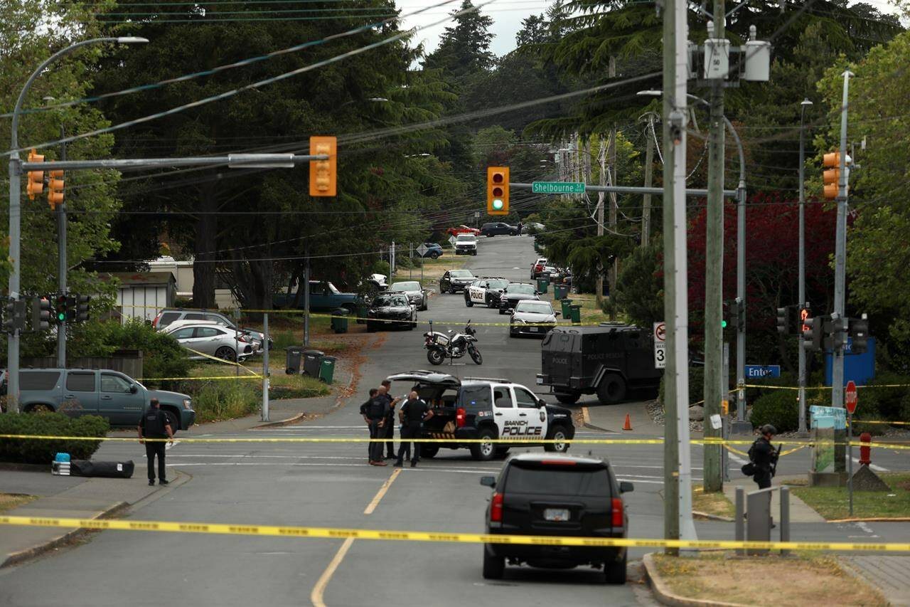 Saanich Police joined by Victoria Police and RCMP respond gunfire involving multiple people and injuries reported at the Bank of Montreal during an active situation in Saanich, B.C., on Tuesday, June 28, 2022. THE CANADIAN PRESS/Chad Hipolito