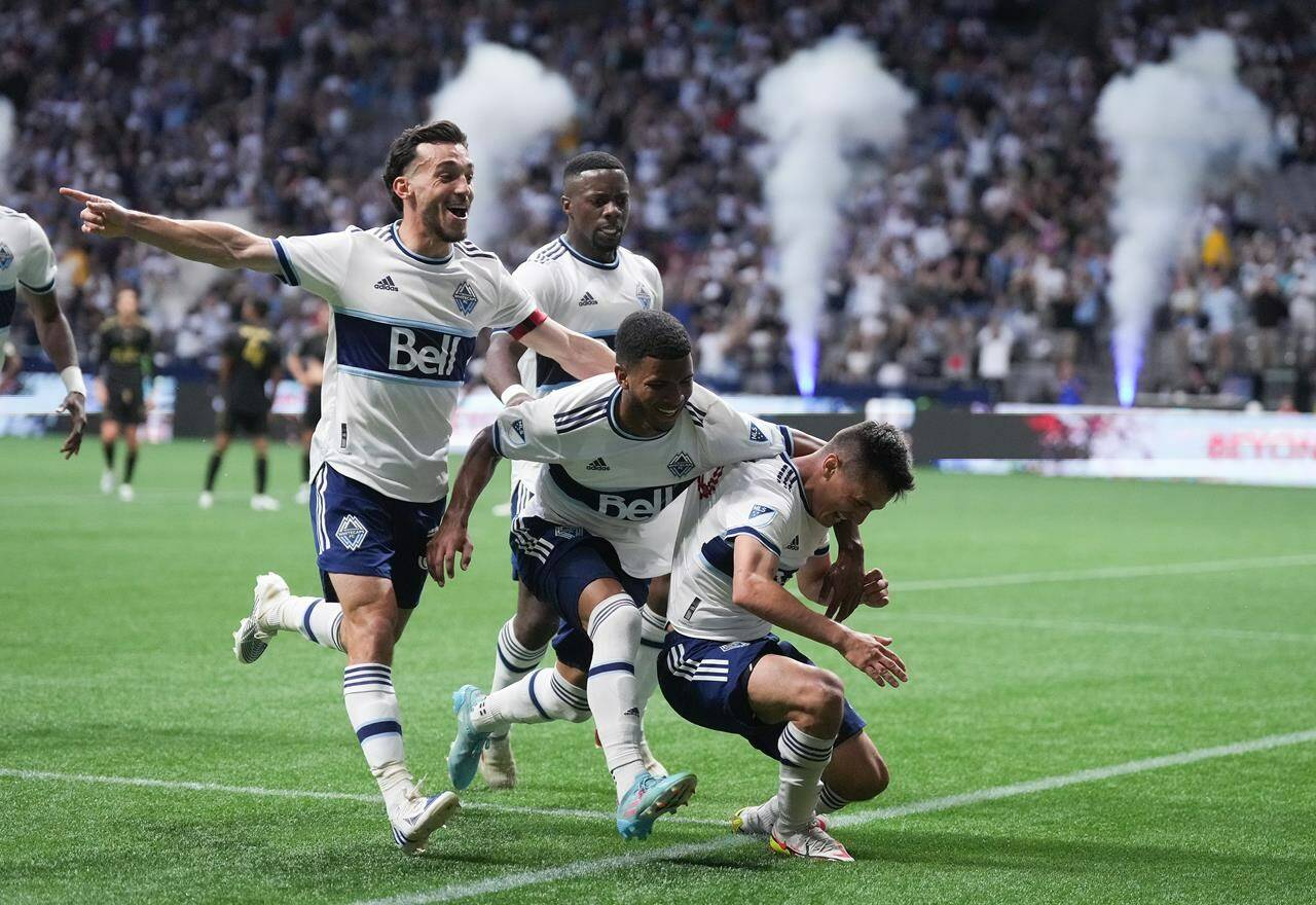 Vancouver Whitecaps’ Russell Teibert, front left to right, Pedro Vite, Andres Cubas and Cristian Dajome, back, celebrate Cubas’ goal against Los Angeles FC during the second half of an MLS soccer game in Vancouver, on Saturday, July 2, 2022. THE CANADIAN PRESS/Darryl Dyck