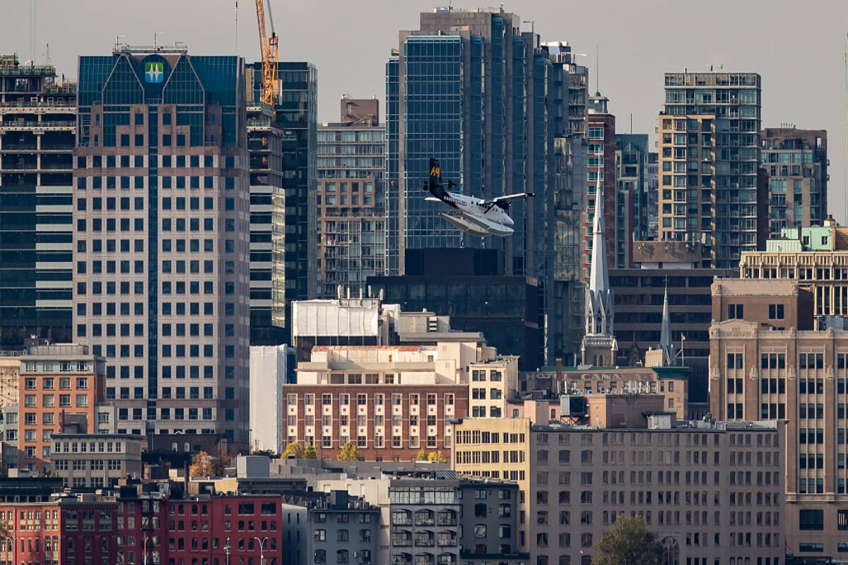 FILE - A seaplane passes the downtown skyline while on approach to land on the harbour in Vancouver. THE CANADIAN PRESS/Darryl Dyck