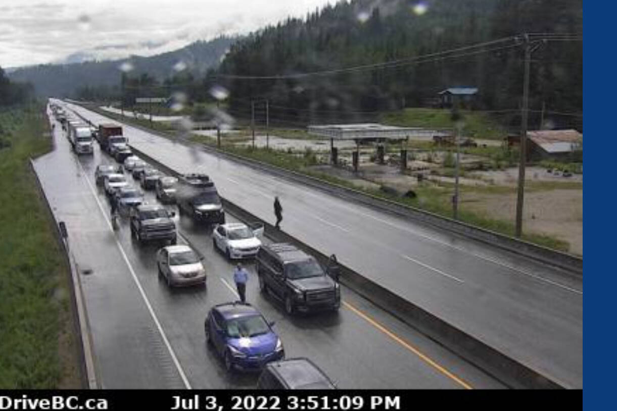 People get out of their vehicles during the complete closure of Highway 1 in Revelstoke, near 3 Valley Gap following a crash Sunday afternoon. (DriveBC)